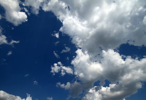 Blue sky background with white fluffy clouds