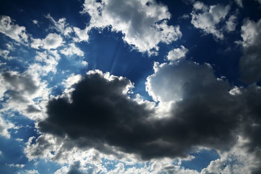 Blue sky background with white fluffy clouds