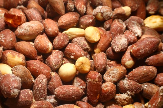 salted roasted peanuts in market, macro close up