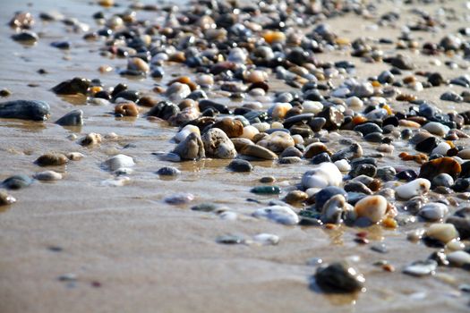 Sea beach with small rocks, close up