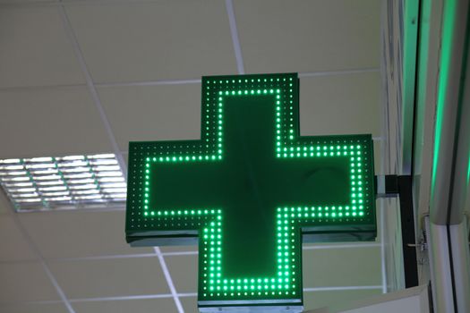 green led light cross symbol for a pharmacy