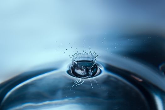 Water splash or drop. Water splash close-up. Blue water drop. Falling water