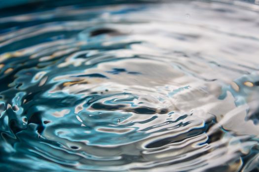 Water splash or drop. Water splash close-up. Blue water drop. Falling water