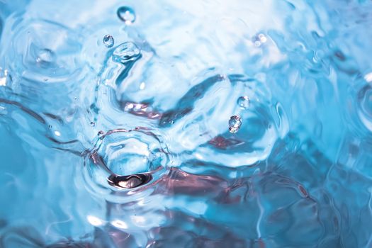 Water splash close-up. Crown of blue water. Water drop