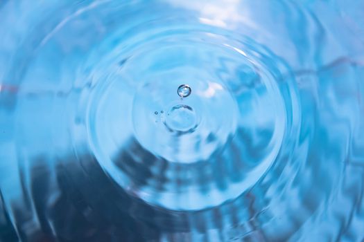 Water splash close-up. Crown of blue water. Water drop