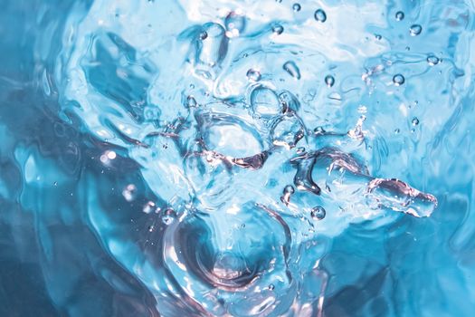 Water splash close-up. Crown of blue water. Water drop
