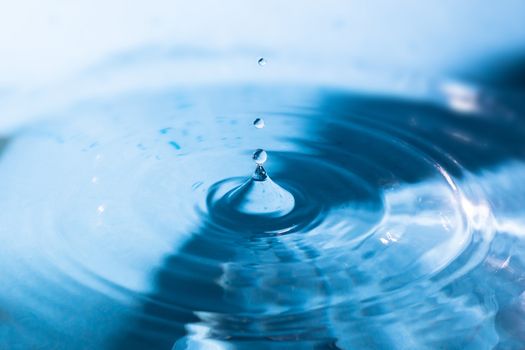 Water splash close-up. Crown of blue water. Water drop. Aqua background