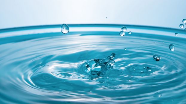 Water splash close-up. Drop of water. Blue water drop. Falling blue water surface with splash and air bubbles