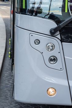 detail of headlight of an urban bus at the station