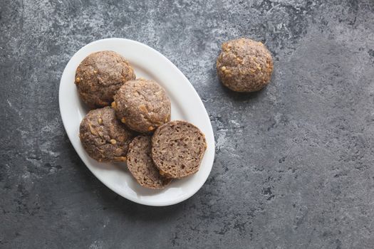 Low carb ketogenic bread on white plate on gray concrete background
