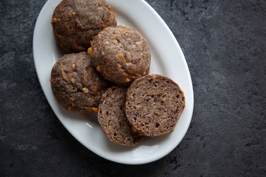 Low carb ketogenic bread on white plate on gray concrete background