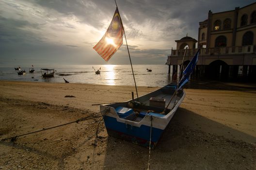 Malaysia flag waxing in sunlight morning.