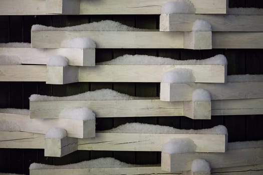 white wooden blocks with snow bstract winter background.