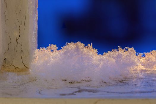 snow flakes on old painted wood with selective focus.