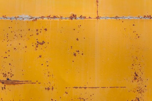 rusted yellow bus board flat background closeup with stains