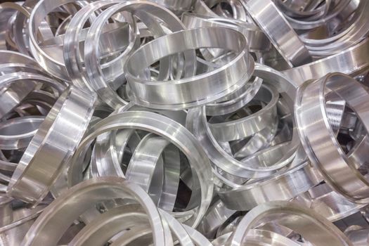 Shiny aluminium cnc turned rings background with selective focus