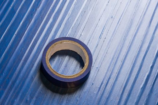 one roll of old blue pvc duct tape on surface covered by same tape