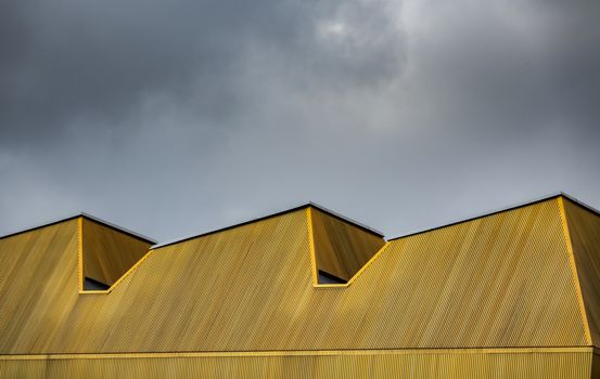 Abstract Architecture Image Of An Urban Modern Yellow Roof Against A Cloudy Sky