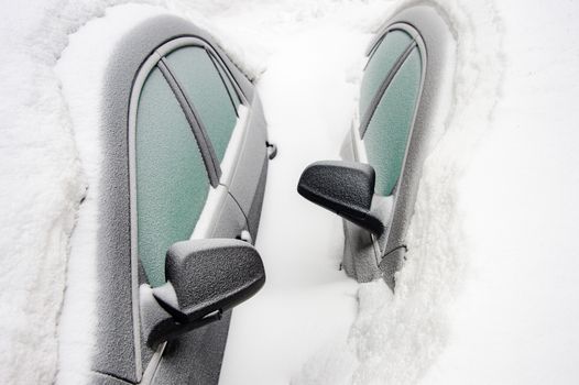 Car mirrors of two cars buried in the snow after snowstorm (Montreal, Canada)