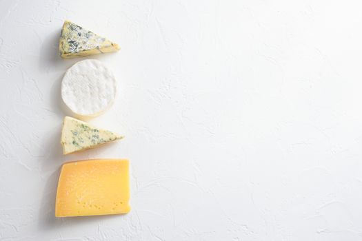 Cheese platter: yellow Maasdam, white Camembert and blue cheese Dor Blue on white background. Copy space. Concept serving cheese. Top view text space for you.