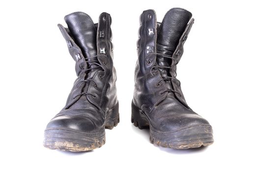 pair of used dirty and dusty military black boots isolated on white background with natural soft shadows