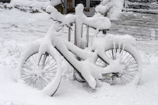 Bike covered with fresh snow in Montreal, Canada, 2018.
