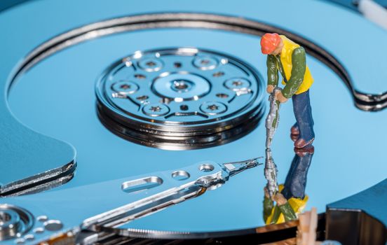 Small mining figurine illustrating concept of artificial intelligence or machine learning using deep data analytics
