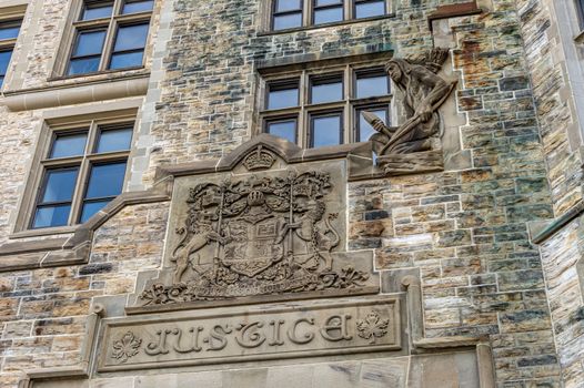 Ottawa, CA - 9 October 2019: Facade of the Justice Building with the Royal Coat of Arms of Canada.