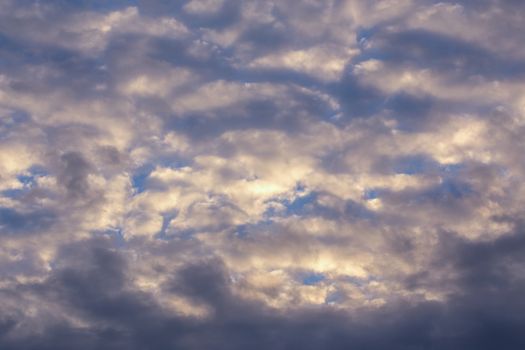 Stratocumulus evening clouds pastel view telephoto background