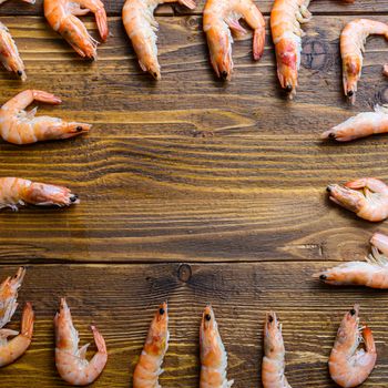 Concept of raw fresh shrimp prawns scuare frame on wood background table with space for text.