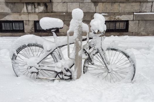 Bike covered with fresh snow in Montreal, Canada, 2018.