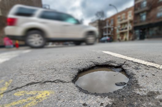 Large unrepaired pothole on Laurier street in Montreal, Canada (2018)