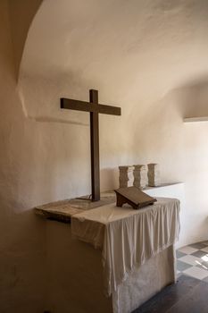 Simple and plain church altar in castle of Predjama built into a cave in Slovenia