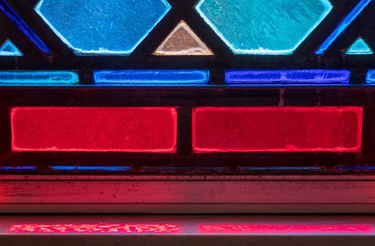 Detail of colored light from stained glass window in catholic church