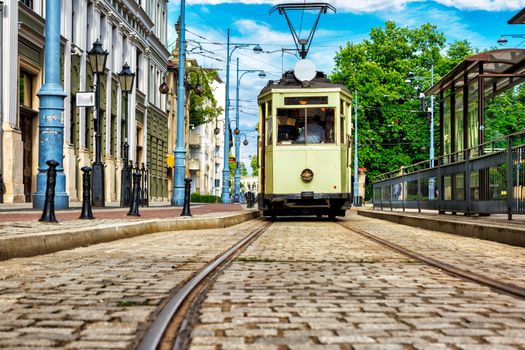 Historic tram line in the city of Wrotclaw. light green wagon ready for shipment