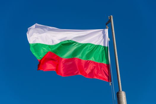 Bulgarian flag waving against blue sky in Boulogne sur Mer, France.