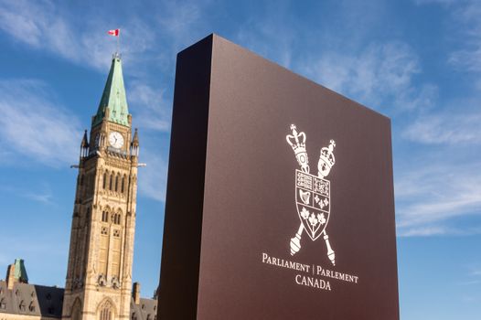 Sign showing Canada Coat of Arms and Canadian Parliament Peace tower in Ottawa