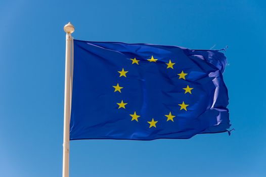 European flag waving against blue sky in Wimereux, France.