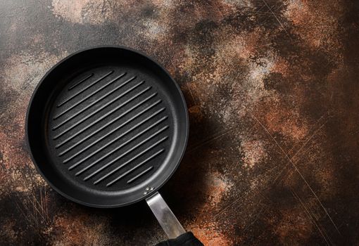 empty cast-iron grill pan and linen cloth on metal rustic table top view space for text