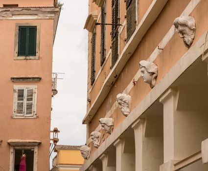 Carvings and sculptures of heads on Bazaar in Old Town in Kerkyra