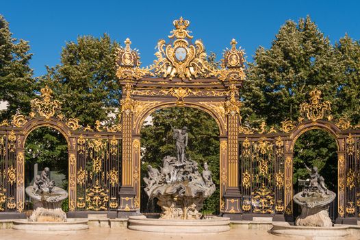 Nancy, France - 22 June 2018: Golden gate to the Place Stanislas square and Neptune Fountain in Nancy, France.