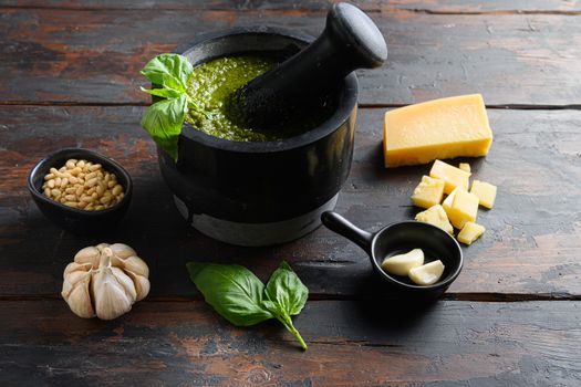 Pesto sauce cooking. Basil, olive oil, parmesan, garlic, pine nuts on Wooden dark board .