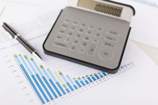 Business analysis - Checking accounting report on business table with calculator