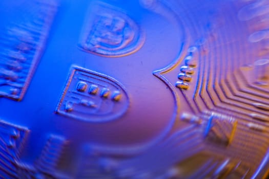 Bitcoin currency coin extreme closeup macro. Playing with color lights