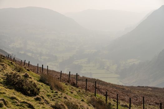 View besides road out of Llangynog in North Wales over the hills to Bala with misty valley behind