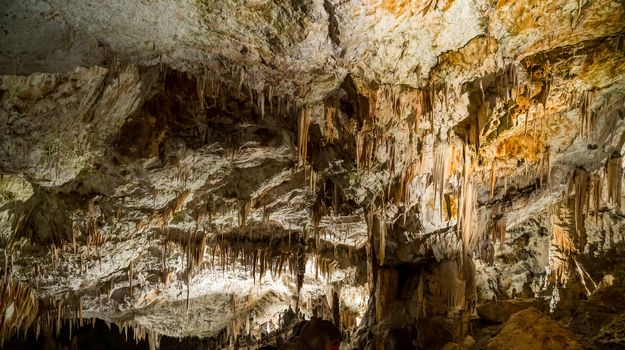 Stalactites and stalagmites underground in cave system in Postojna