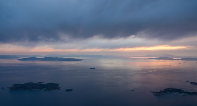 View of coastline and islands near Athens airport as plane descends at sunset