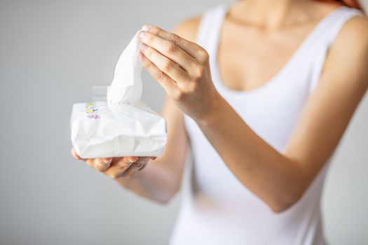 Wet wipes are universal an practical: woman take one wipe from big package for cleaning