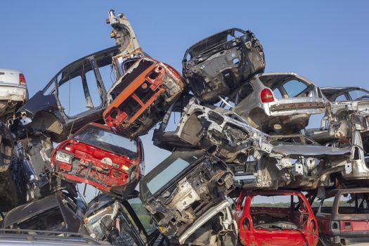 Old cars stack - Car junkyard - damaged vehicles waiting for metal recycling