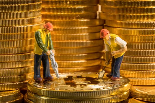 Concept illustration of two miners mining new bit-coin cybercurrency virtual coins in the blockchain